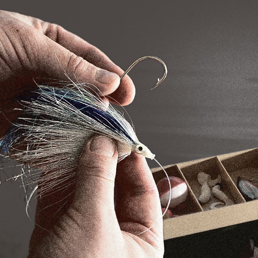 A fisherman baits a hook